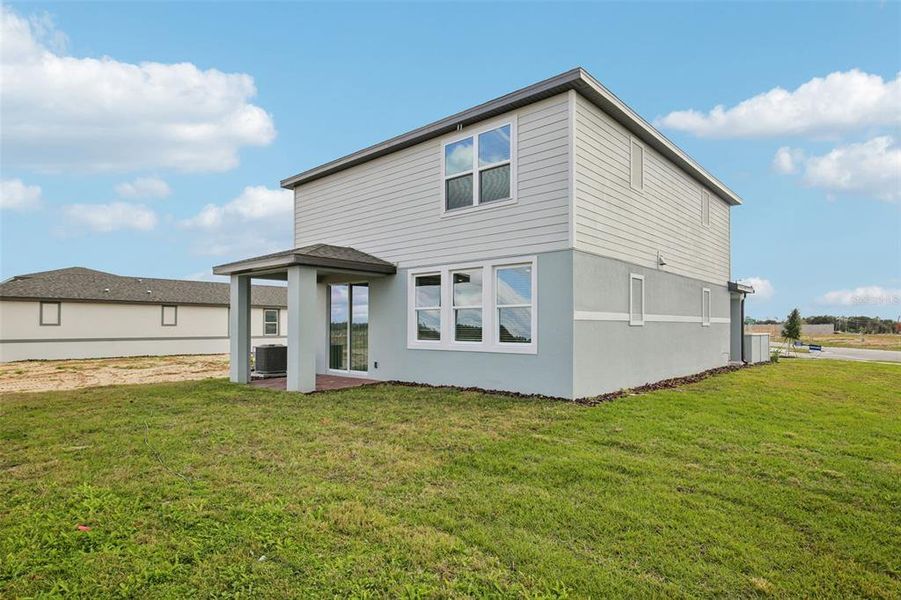 Exterior details and patio area of a home in Springs at Lake Alfred - Classic Series, Lake Alfred (Image 3).