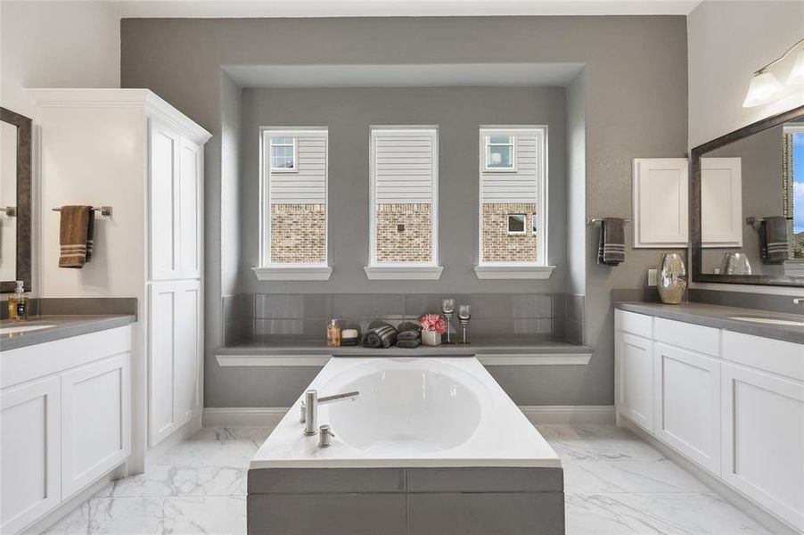 Bathroom with vanity and a bath