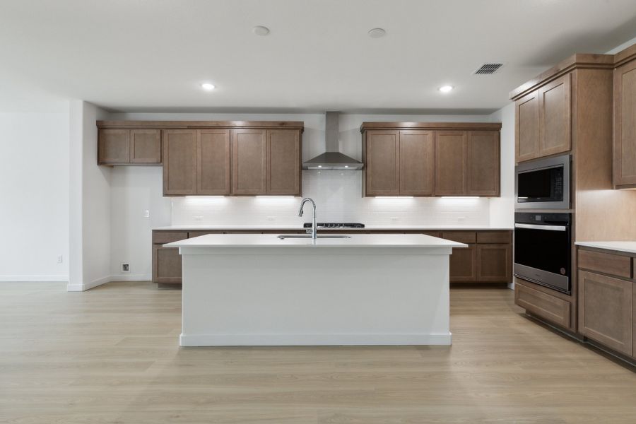 Kitchen in the Presley II home plan by Trophy Signature Homes – REPRESENTATIVE PHOTO