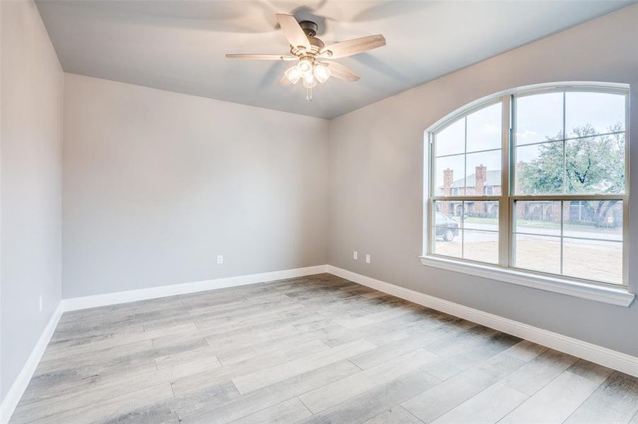 Unfurnished room featuring ceiling fan and light hardwood / wood-style flooring