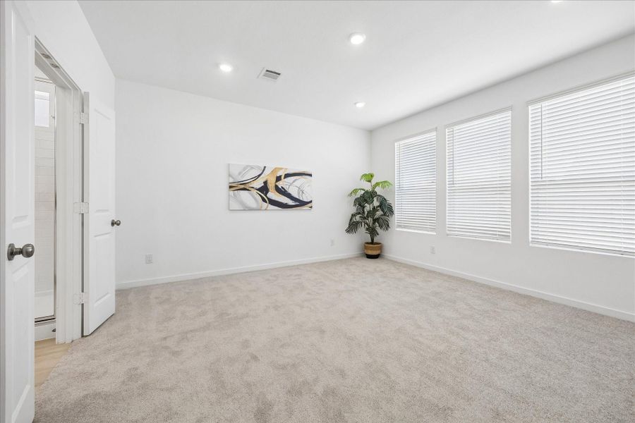 Consider this your permission to hit snooze. Tucked at the back of the home, this spacious owner’s retreat pairs soft neutral finishes, plush carpet and abundant natural light with plenty of room to stretch out, slow down and unwind.