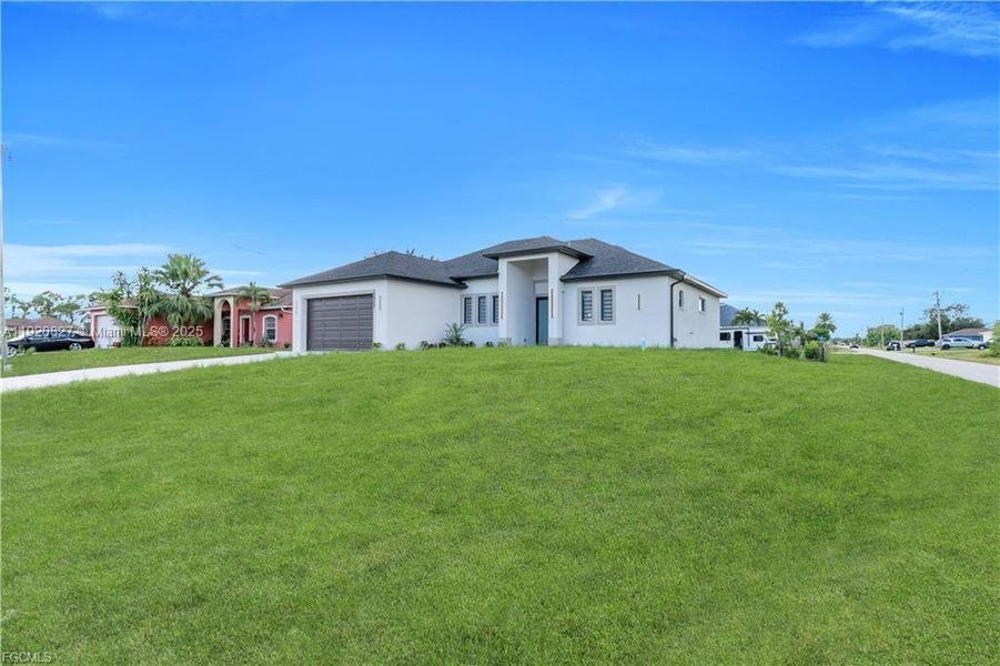 Front exterior of a new home in , Lehigh Acres, FL, highlighting curb appeal (Image 24). Front exterior of a new home in , Lehigh Acres, FL, highlighting curb appeal (Image 24).