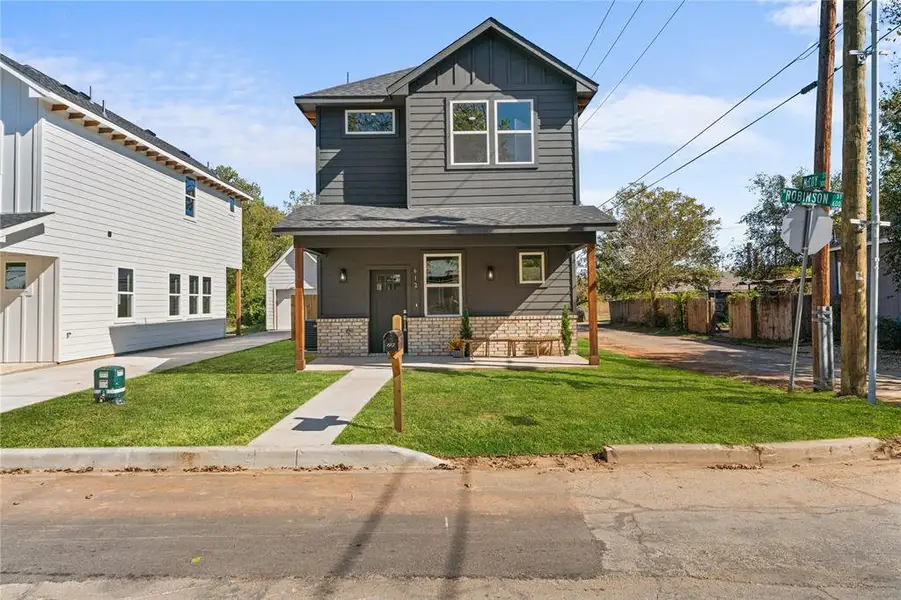 Front exterior of a new home in , Cleburne, TX, highlighting curb appeal (Image 2).