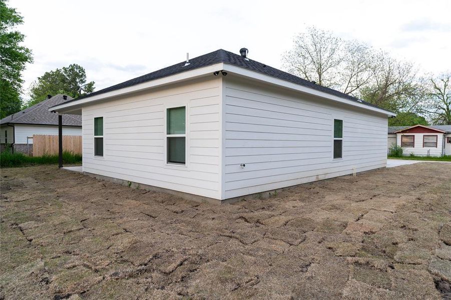 View of side of home with fence View of side of home with fence