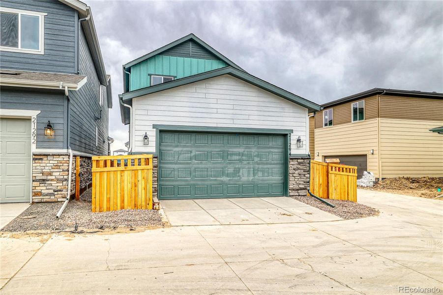 Front exterior of a new home in Painted Prairie, Aurora, CO, highlighting curb appeal (Image 17).