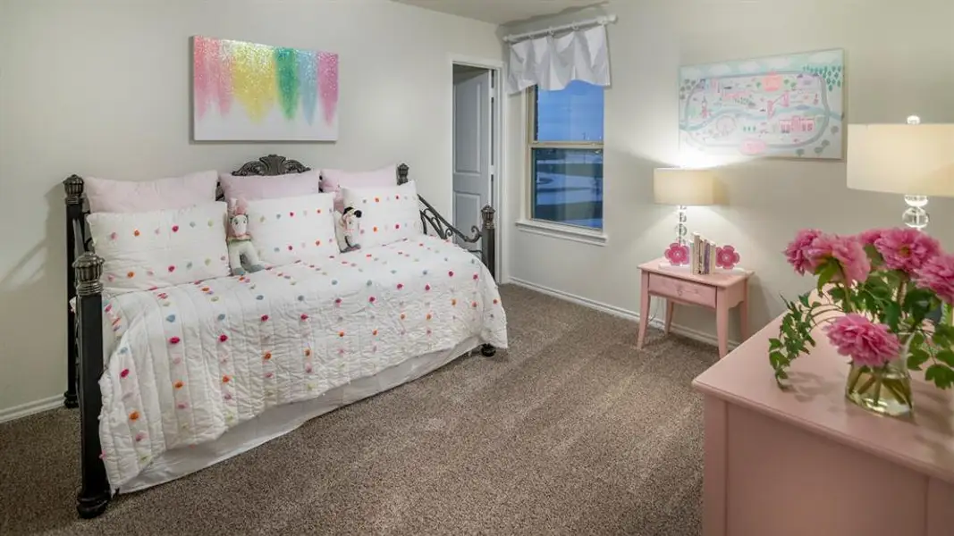 Bedroom with dark colored carpet and baseboards