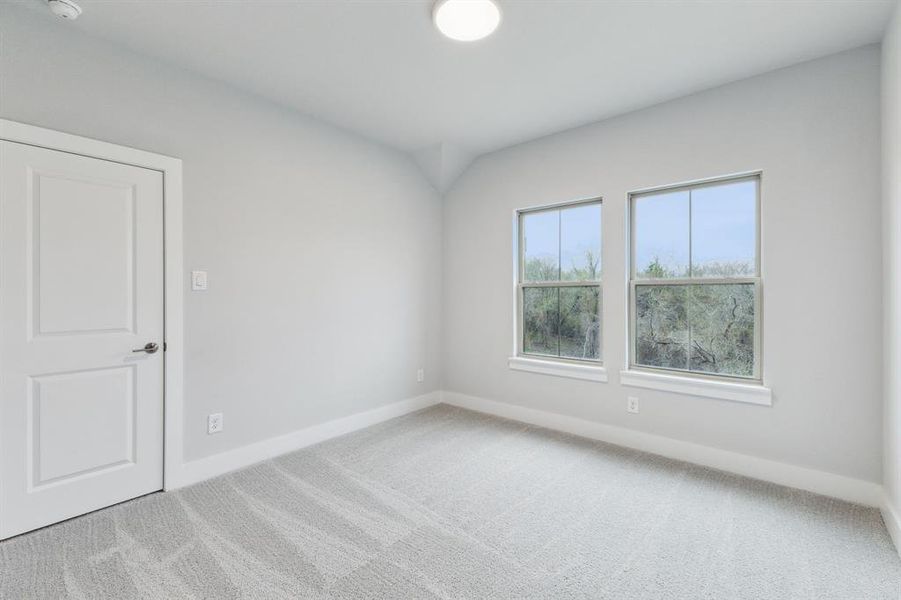 Spare room with carpet and a smoke detector