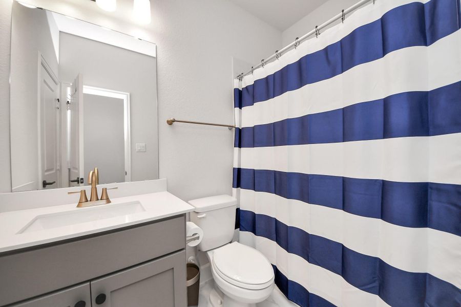 Secondary bathroom with vanity and tub/shower combination.