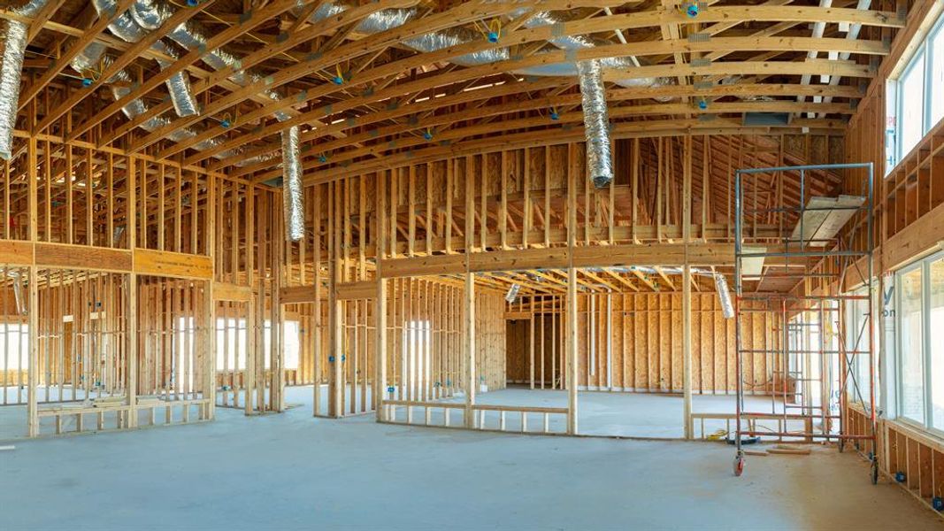 Misc room with concrete floors and a towering ceiling
