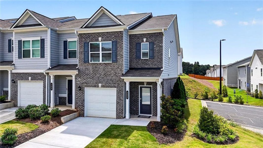 Front exterior of a new home in Fuller Station, Loganville, GA, highlighting curb appeal (Image 28).