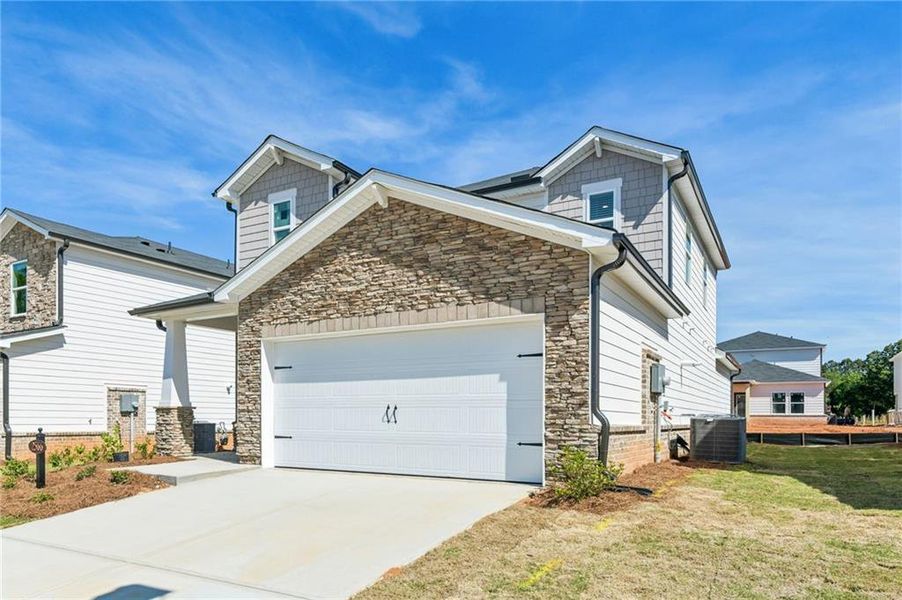 Front exterior of a new home in Martin Springs - Reserve Series, Lawrenceville, GA, highlighting curb appeal (Image 26).