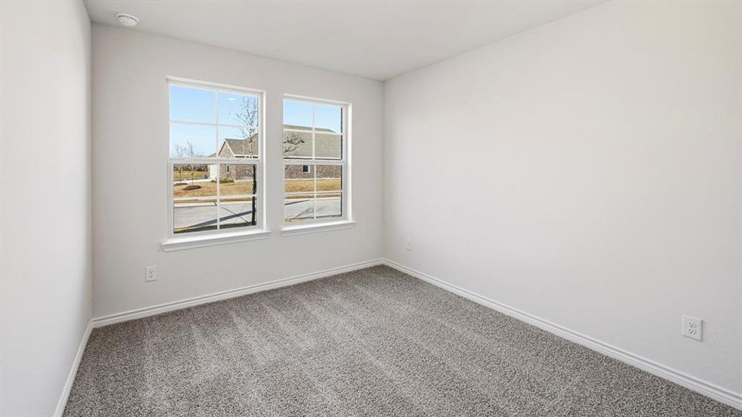 Carpeted spare room featuring baseboards Carpeted spare room featuring baseboards