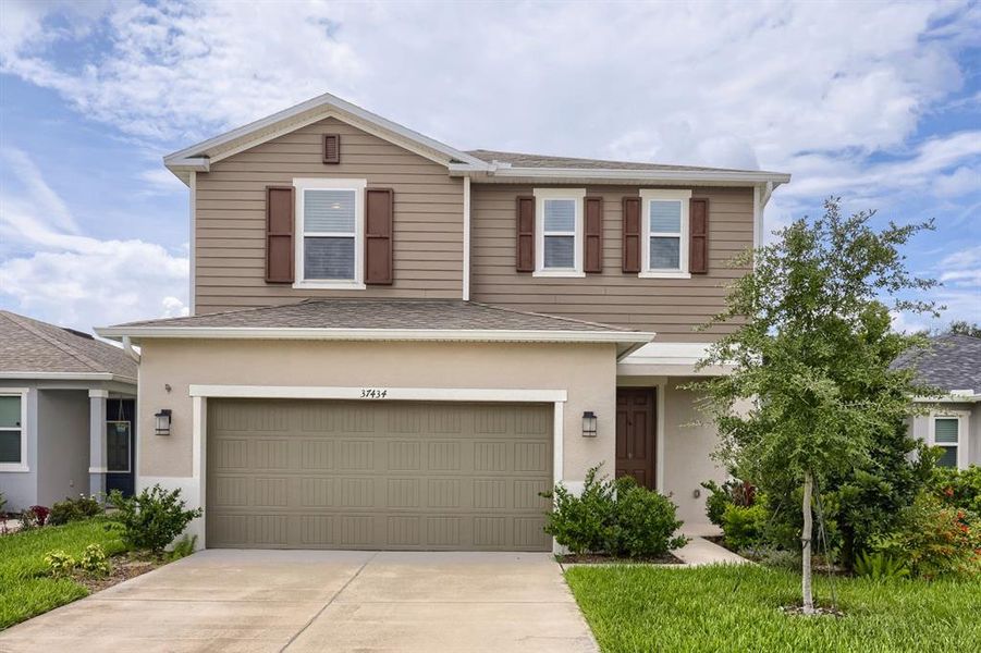 Front exterior of a new home in , Zephyrhills, FL, highlighting curb appeal (Image 2). Front exterior of a new home in , Zephyrhills, FL, highlighting curb appeal (Image 2).