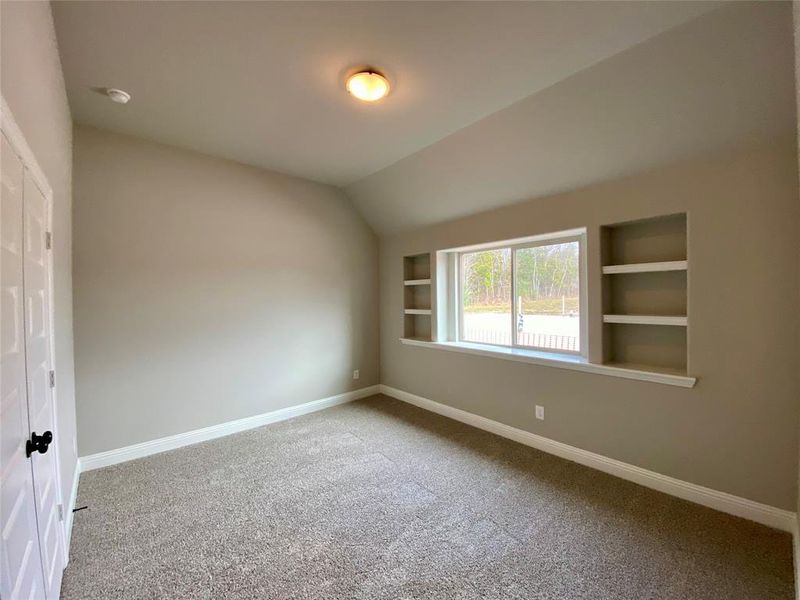Bed 2 with vaulted ceiling & built-in shelves Bed 2 with vaulted ceiling & built-in shelves