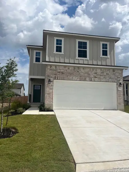 Front exterior of a new home in Highland Ridge, New Braunfels, TX, highlighting curb appeal (Image 2).