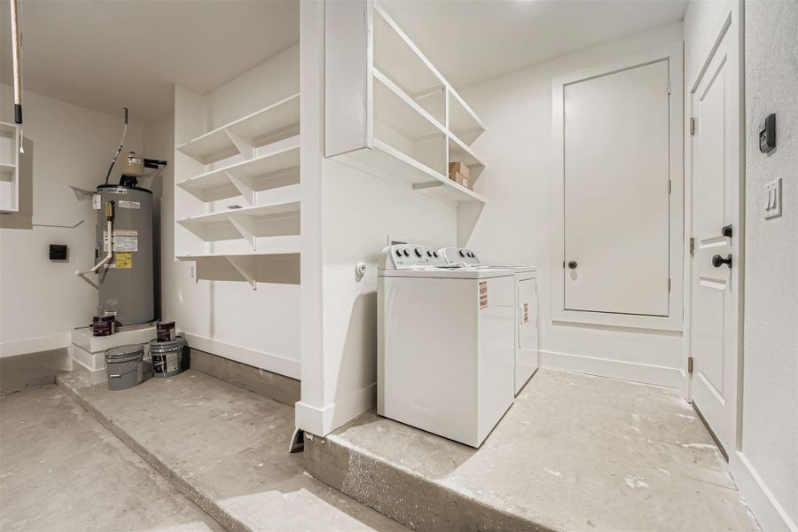 Washroom with water heater and separate washer and dryer Washroom with water heater and separate washer and dryer