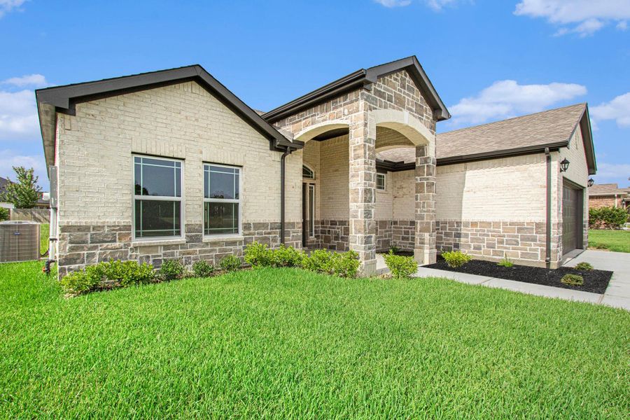 Front exterior of a new home in Columbia Lakes, West Columbia, TX, highlighting curb appeal (Image 2).