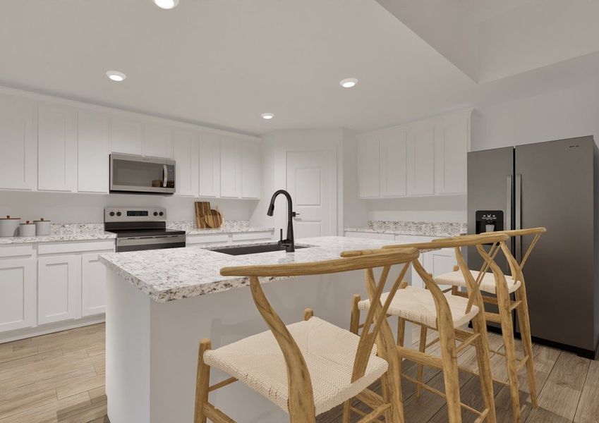 Modern kitchen with white cabinets, granite countertops, and stainless steel appliances, including a fridge and oven. Three wooden bar stools beside the island add warmth to the space.