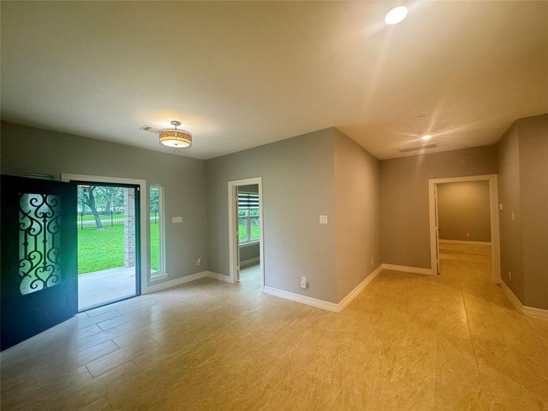 Reverse view of entrance with study room in middle, primary bedroom and hallway to the right
