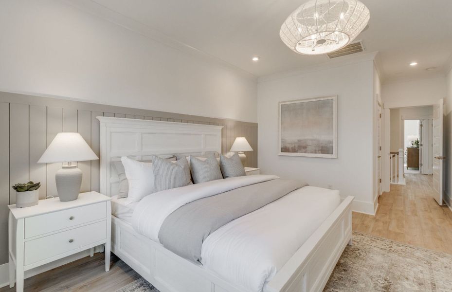 Owner's Suite with hardwood floors and a beautiful pendant light fixture.