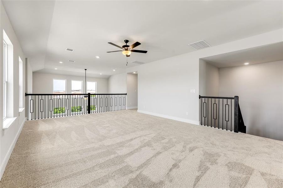 The stair case and balcony railing are a beautiful wood/wrought iron finish.