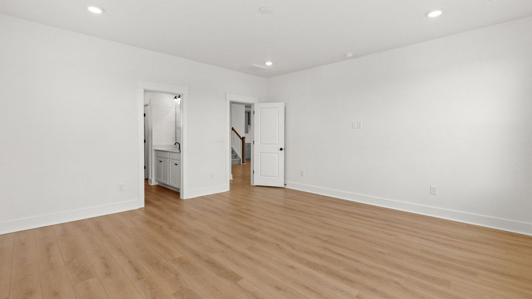 The primary suite flows seamlessly into a private bath and walk-in closet.