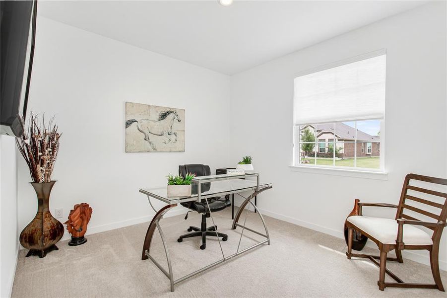 This room features light-colored carpeting and a window with a white blind