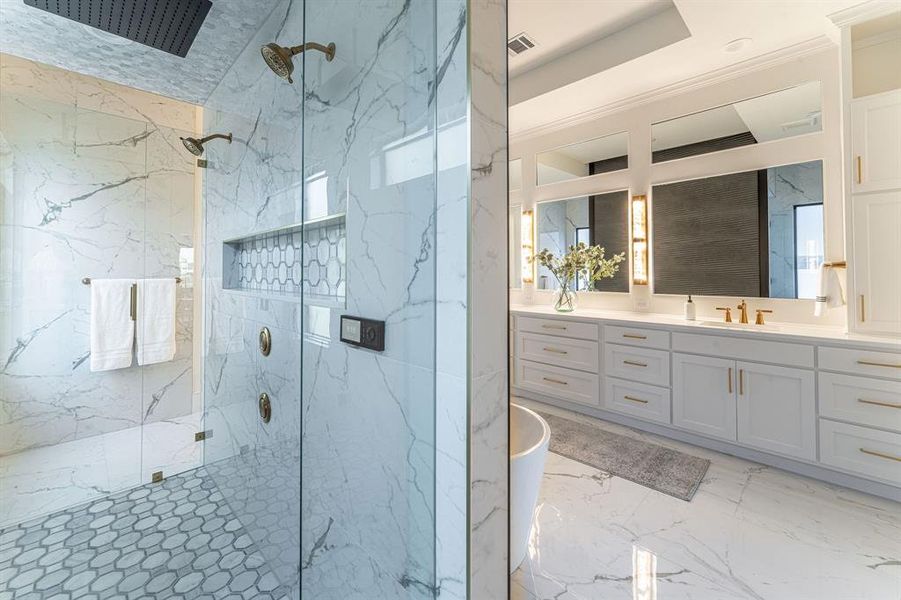 Bathroom featuring vanity, tile patterned flooring, crown molding, a raised ceiling, and a shower with door