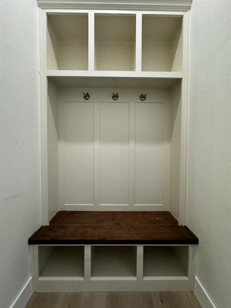 Mudroom with wood-type flooring