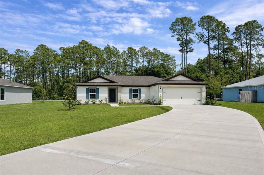 Front exterior of a new home in Palm Coast, Palm Coast, FL, highlighting curb appeal (Image 1). Front exterior of a new home in Palm Coast, Palm Coast, FL, highlighting curb appeal (Image 1).