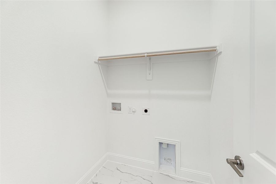 Laundry room with upper shelf, hanging rod, washer and dryer hookups, and marble tile floor Laundry room with upper shelf, hanging rod, washer and dryer hookups, and marble tile floor