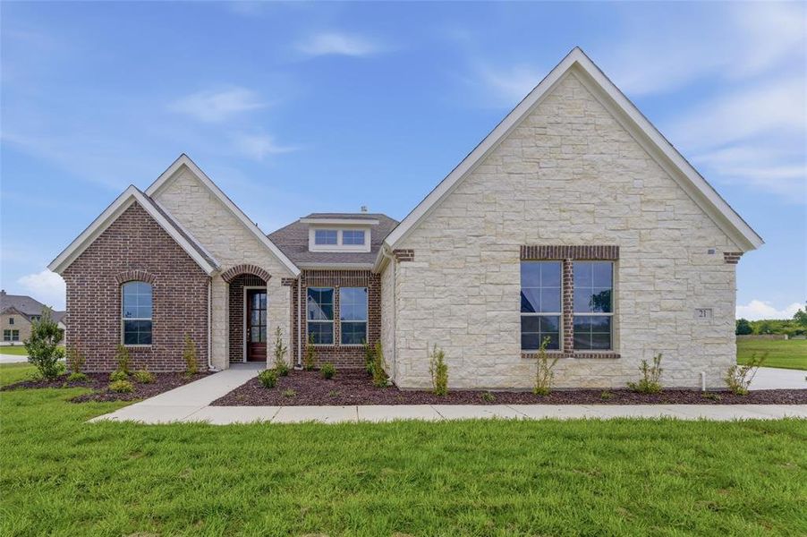The property features a mixed material exterior with brick and stone, a gabled roof, and an arched entry