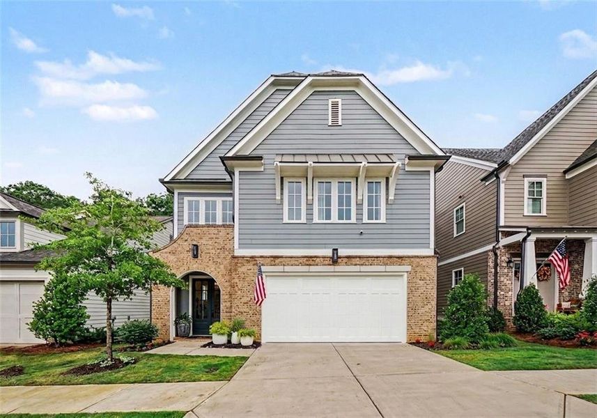 Front exterior of a new home in Lakeside at River Green, Canton, GA, highlighting curb appeal (Image 2). Front exterior of a new home in Lakeside at River Green, Canton, GA, highlighting curb appeal (Image 2).