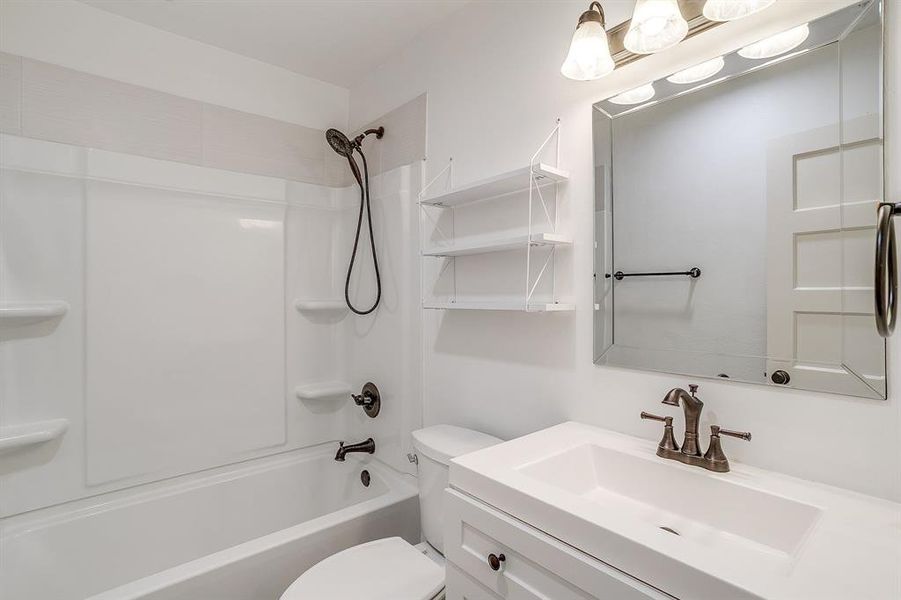 Updated bathroom with vanity and shower / washtub combination
