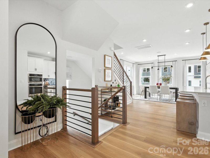 Second floor landing with oak box stairs and black metal balusters Second floor landing with oak box stairs and black metal balusters