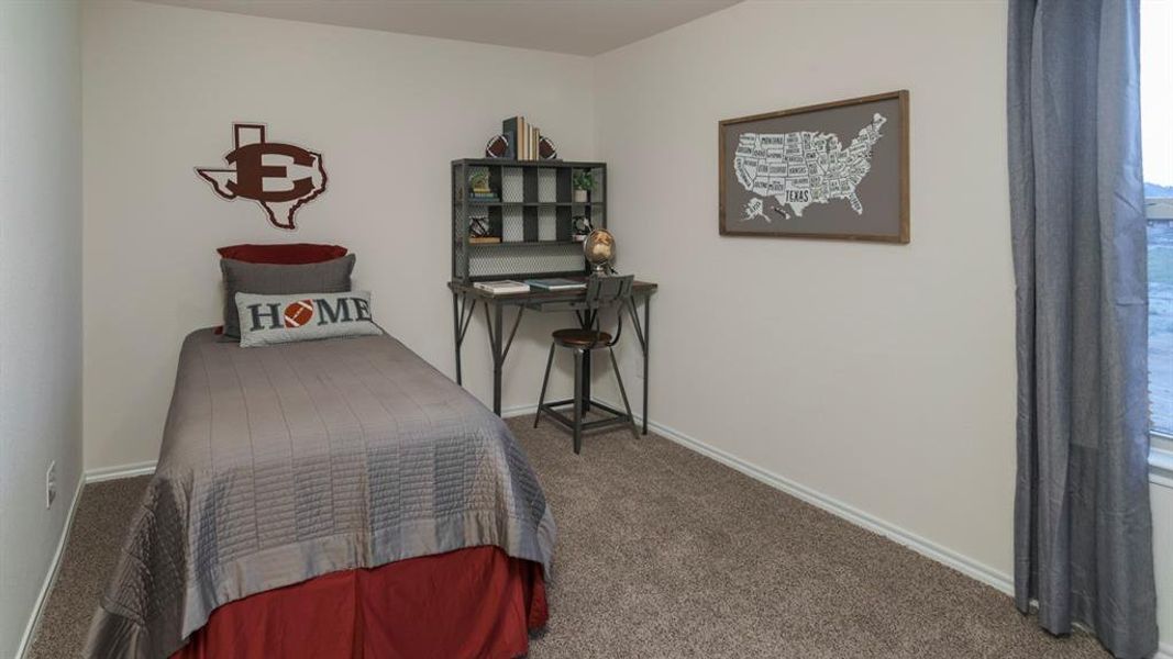 Carpeted bedroom featuring baseboards