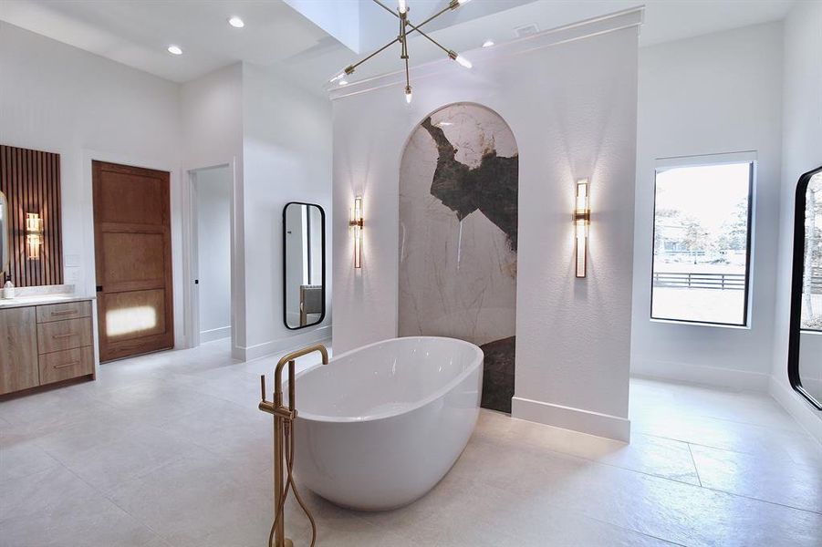 The custom finishes to this luxurious primary bathroom are astonishing!