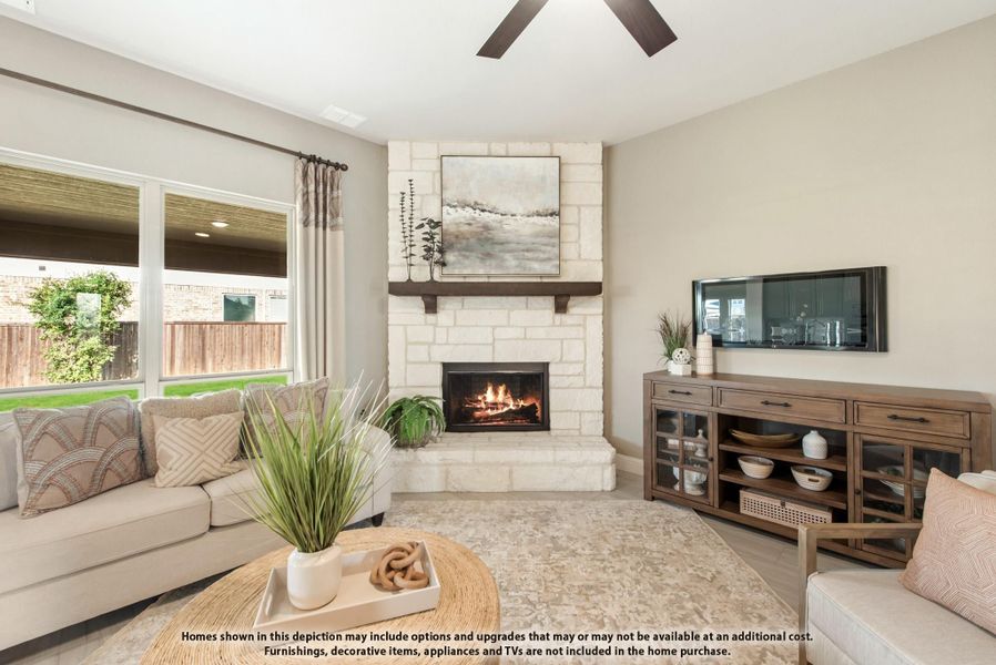 Living room with stone corner fireplace, neutral sofa, ceiling fan, and wood media console near large window