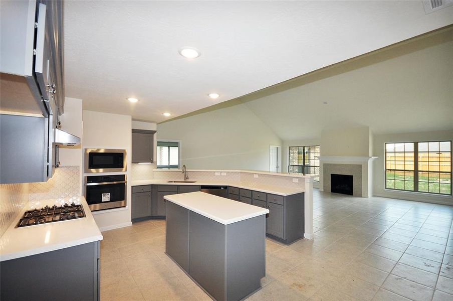 The C. tile flooring continues through the kitchen and into the family room.