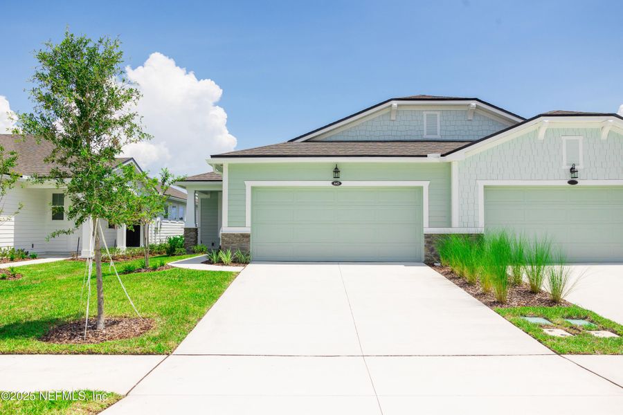Front exterior of a new home in RiverTown - WaterSong, St. Johns, FL, highlighting curb appeal (Image 20).