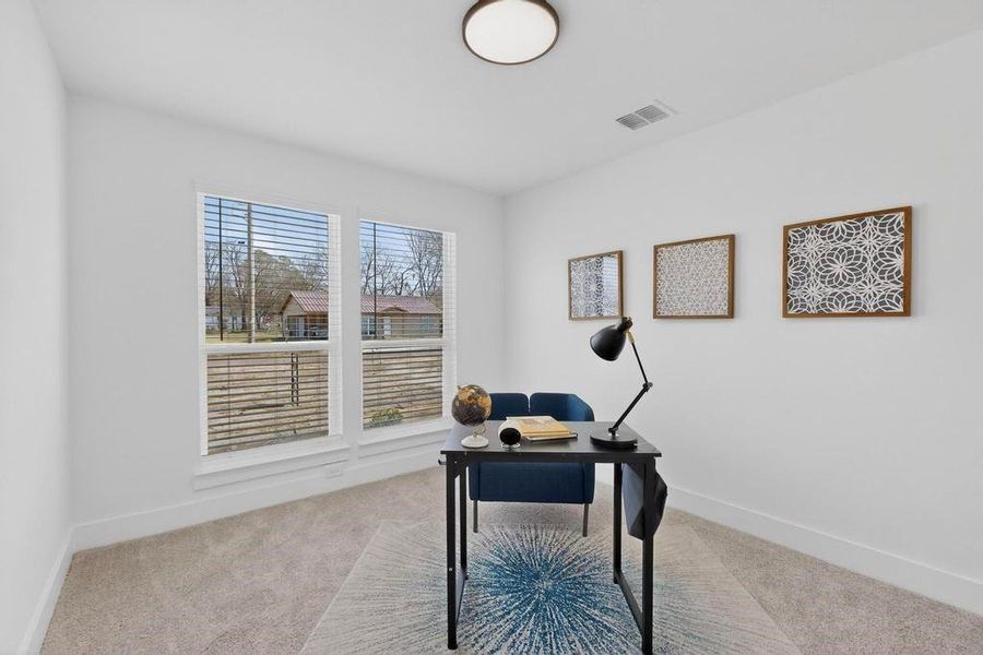 Home office featuring light colored carpet and baseboards Home office featuring light colored carpet and baseboards