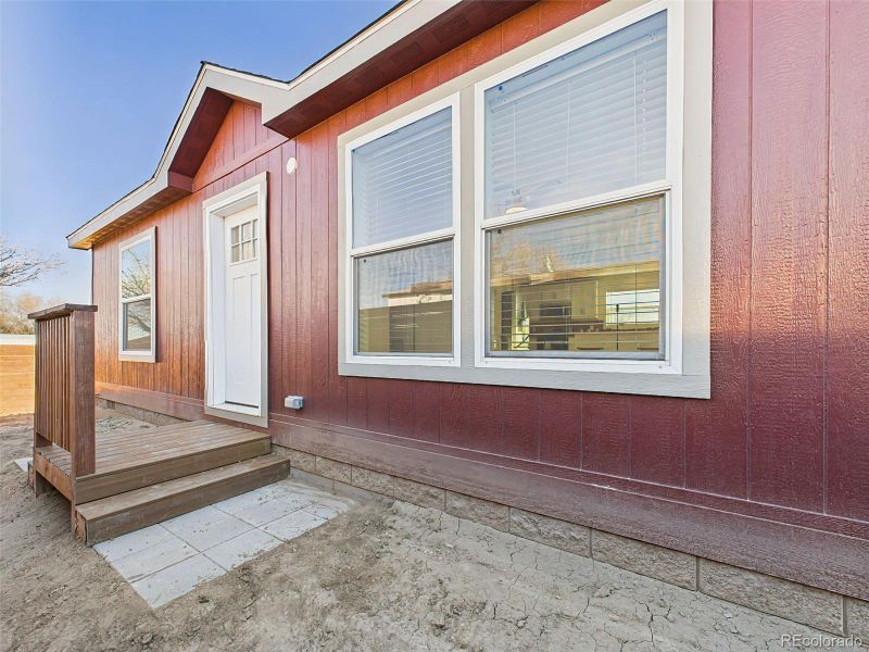 Front door porch located in fenced area