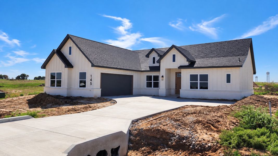 Front exterior of a new home in Stagecoach Crossing, Bridgeport, TX, highlighting curb appeal (Image 2). Front exterior of a new home in Stagecoach Crossing, Bridgeport, TX, highlighting curb appeal (Image 2).