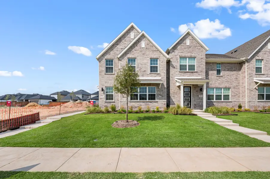 Front exterior of a new home in Trinity Falls, McKinney, TX, highlighting curb appeal (Image 1). Front exterior of a new home in Trinity Falls, McKinney, TX, highlighting curb appeal (Image 1).