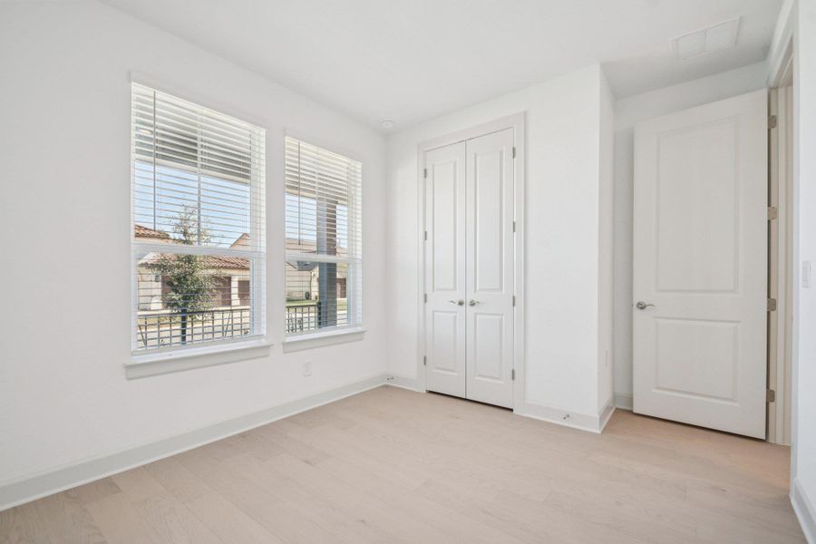 Unfurnished bedroom with light wood-style flooring and a closet Unfurnished bedroom with light wood-style flooring and a closet