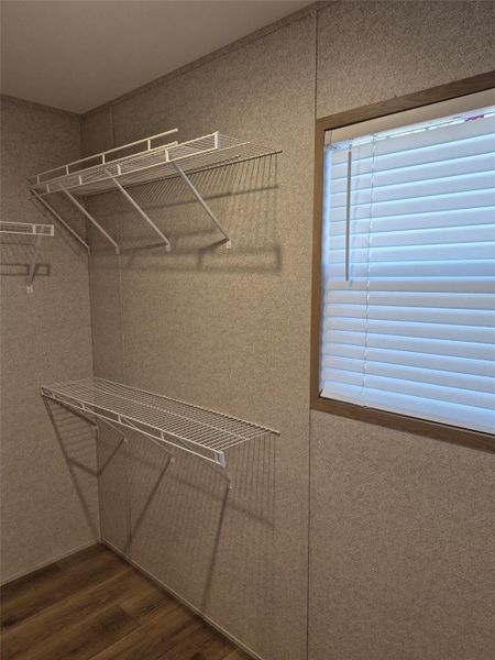 Walk in closet featuring dark wood-style floors