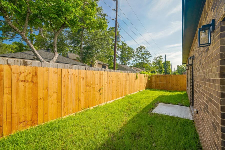 Fenced backyard with plenty of space for pets and play