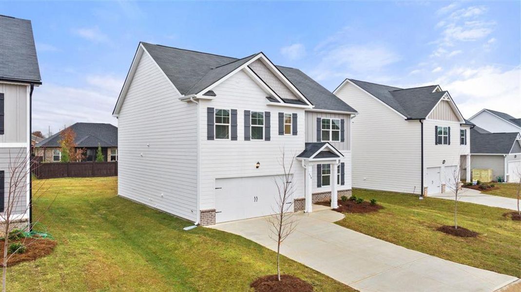 Front exterior of a new home in Champion's Run, Lithonia, GA, highlighting curb appeal (Image 2). Front exterior of a new home in Champion's Run, Lithonia, GA, highlighting curb appeal (Image 2).