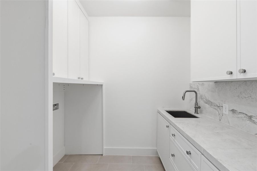Convenient and functional, the well-appointed utility room features built-in storage and a utility sink designed to simplify everyday tasks.