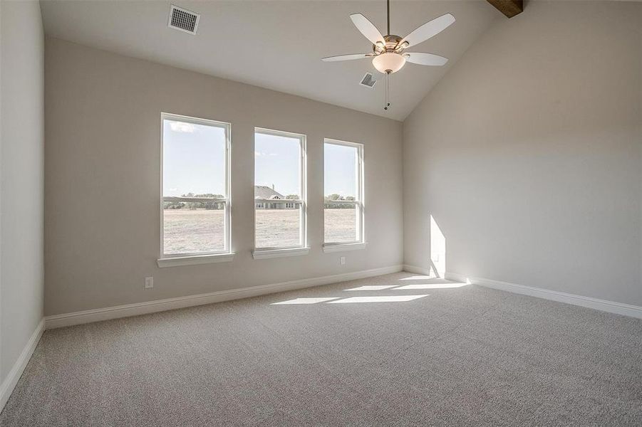 Spare room featuring high vaulted ceiling, carpet, and ceiling fan